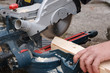 Carpenter sawing plank
