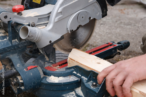 Photo: Carpenter sawing plank Carpenter sawing plank