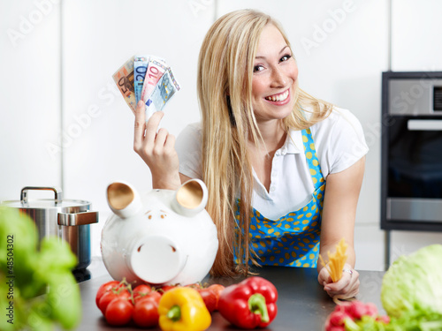 Photo: Woman in kitchen saves ready cash with cooking by herself Woman in kitchen saves ready cash with cooking by herself