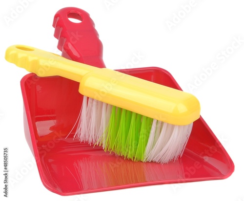 Photo: A dustpan and brush on a white background A dustpan and brush on a white background