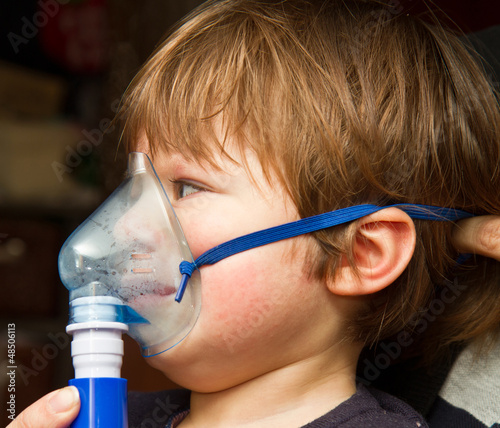 Photo: child taking respiratory, inhalation therapy. child taking respiratory, inhalation therapy.