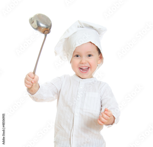 Photo: Smiling little boy in chef's hat holding ladle. Smiling little boy in chef's hat holding ladle.