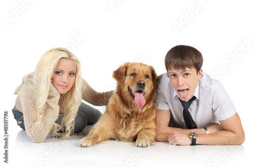 Photo: Couple with a dog lying on a white background Couple with a dog lying on a white background