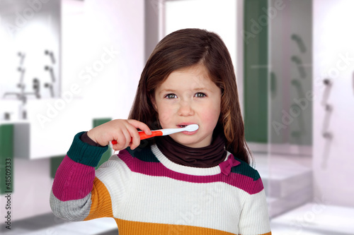 Photo: Pretty little girl brushing teeth Pretty little girl brushing teeth