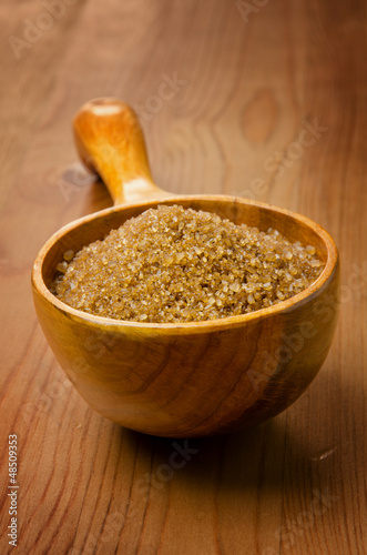 Photo: Cane sugar in a wooden spoon Cane sugar in a wooden spoon
