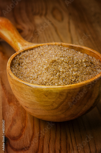 Photo: Cane sugar in a wooden spoon Cane sugar in a wooden spoon