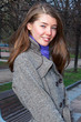 Photo: Beautiful and young woman resting in a park in autumn Beautiful and young woman resting in a park in autumn
