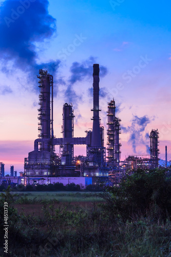 Photo: oil refinery plant and smoke at twilight morning oil refinery plant and smoke at twilight morning