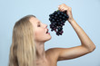 Young girl holding a bunch of grapes