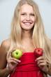 Bright spring portrait of happy healthy woman holding apple