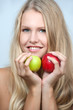 Bright spring portrait of happy healthy woman holding apple