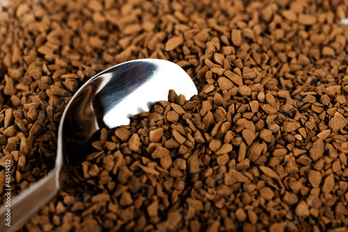 Photo: Spoon of coffee at coffe background Spoon of coffee at coffe background