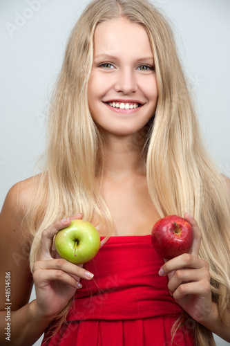 Photo: Bright spring portrait of happy healthy woman holding apple Bright spring portrait of happy healthy woman holding apple