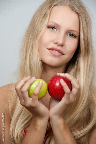 Photo: Bright spring portrait of happy healthy woman holding apple Bright spring portrait of happy healthy woman holding apple