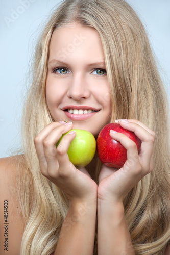 Photo: Bright spring portrait of happy healthy woman holding apple Bright spring portrait of happy healthy woman holding apple