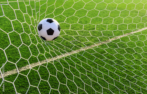 Photo: soccer ball in goal net soccer ball in goal net