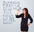 Photo: Woman drawing business scheme and icons on whiteboard Woman drawing business scheme and icons on whiteboard