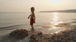 Video: little boy playing in the sand on the beach at sunset little boy playing in the sand on the beach at sunset