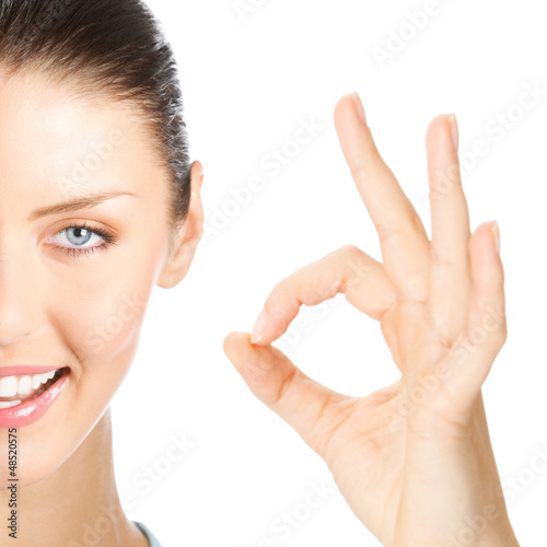 Photo: Happy smiling woman with okay gesture, isolated Happy smiling woman with okay gesture, isolated