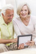 Senior Man & Woman Couple Using Tablet Computer
