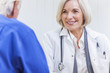 Senior Female Doctor With Male Patient