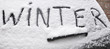 Word Winter written on snowy rear screen car