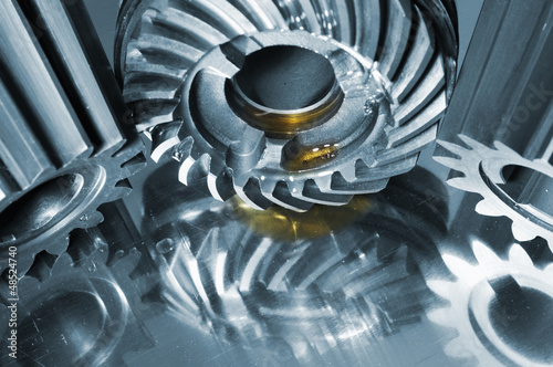 Photo: gears, wheels and cogs with drops of oil and in blue toning gears, wheels and cogs with drops of oil and in blue toning