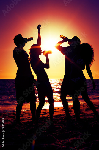 Photo: People having party at beach with drinks People having party at beach with drinks