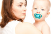 Mother with adorable baby with soother (focus on woman)