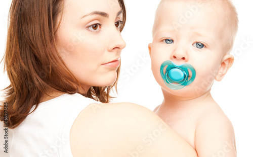 Photo: Mother with adorable baby with soother (focus on woman) Mother with adorable baby with soother (focus on woman)