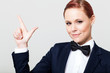 cute young woman in suit with bow tie making hand sign
