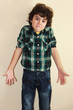 Studio portrait of an attractive boy with funny expression