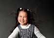 charming girl with flying hair and dimples on her cheeks