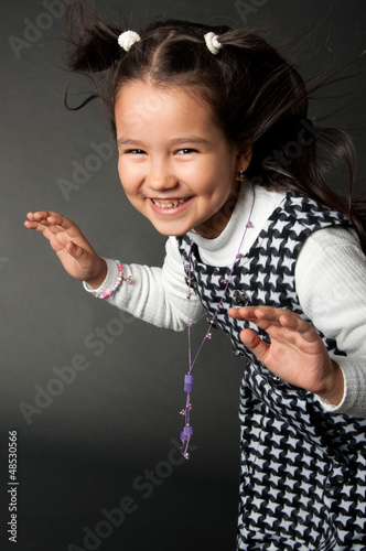 Photo: charming girl with flying hair and dimples on her cheeks charming girl with flying hair and dimples on her cheeks