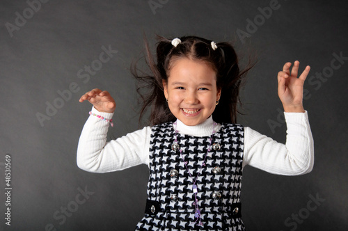 Photo: charming girl with flying hair and dimples on her cheeks charming girl with flying hair and dimples on her cheeks