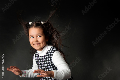 Photo: charming girl with flying hair and dimples on her cheeks charming girl with flying hair and dimples on her cheeks