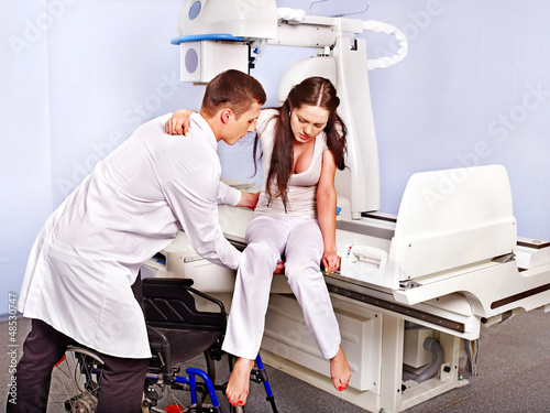 Photo: Patient and doctor in x-ray room. Patient and doctor in x-ray room.