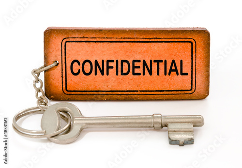 Photo: old key with confidential leather tag isolated white old key with confidential leather tag isolated white