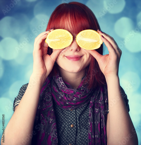Photo: Chill girl in scarf keep lemon instead of eye Chill girl in scarf keep lemon instead of eye