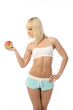 Athletic girl offering an apple