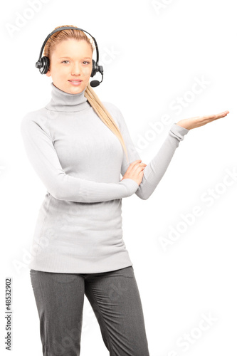 Photo: Female customer service operator with headphones gesturing Female customer service operator with headphones gesturing