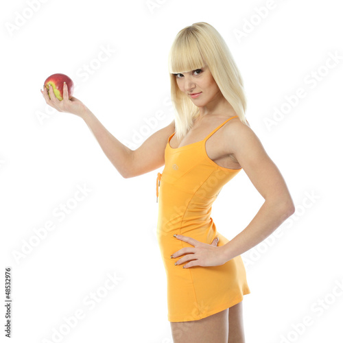 Photo: Athletic girl offering an apple Athletic girl offering an apple