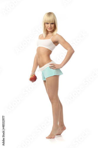 Photo: Athletic girl offering an apple Athletic girl offering an apple