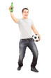 Euphoric sport fan holding a beer bottle and football