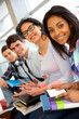Group of cheerful teenagers sitting on school bench