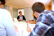 Teacher giving business presentation to students