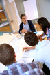 Teacher giving business presentation to students