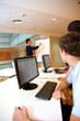 Teacher in lab doing presentation on whiteboard