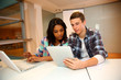 Teenagers in class using electronic tablet