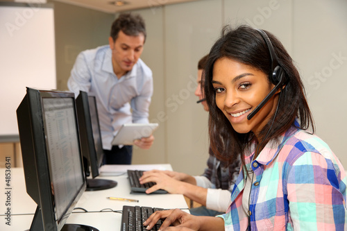 Photo: Portrait of cheerful young woman with headset on Portrait of cheerful young woman with headset on